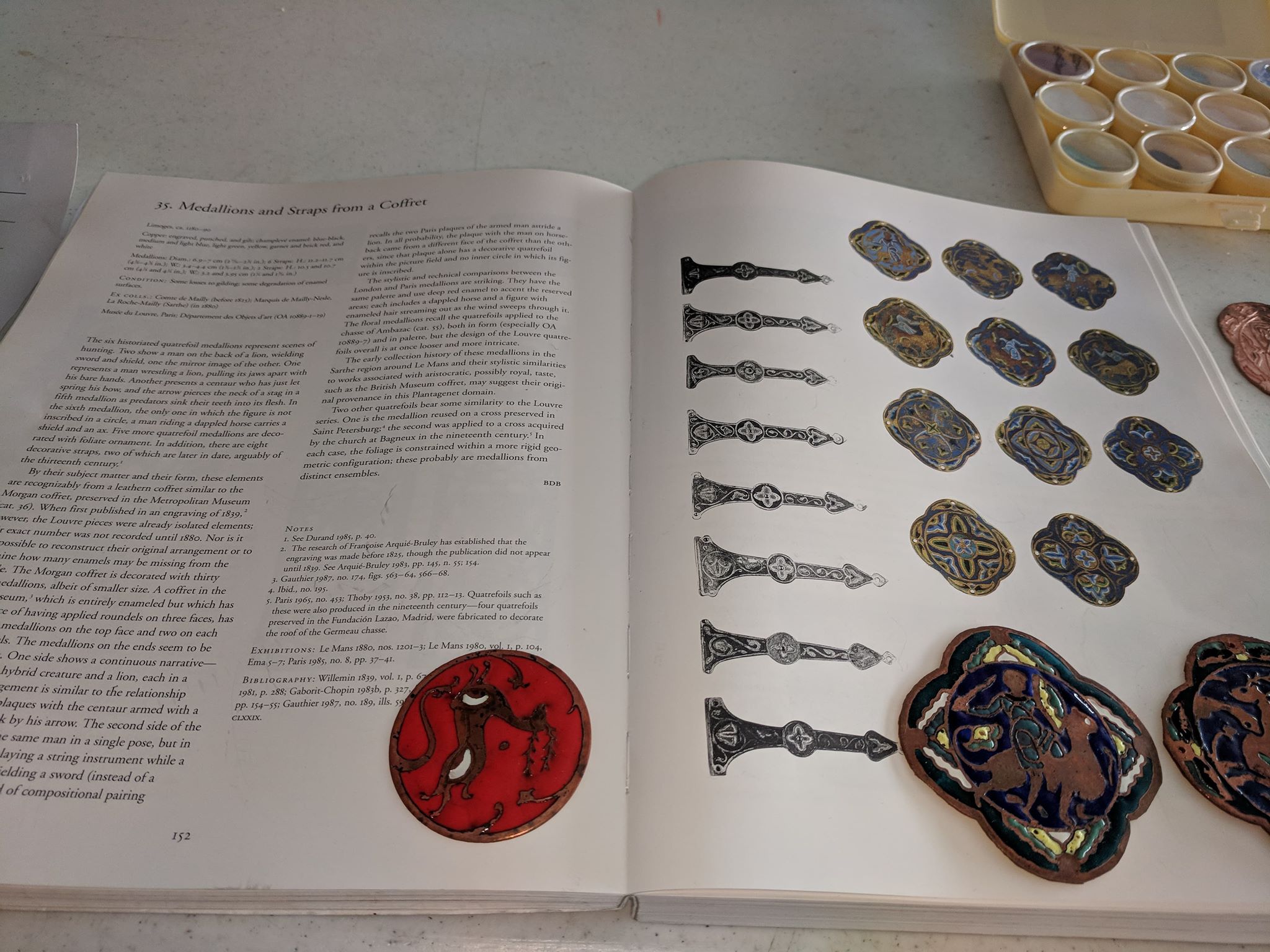 Some enamels next to the source book