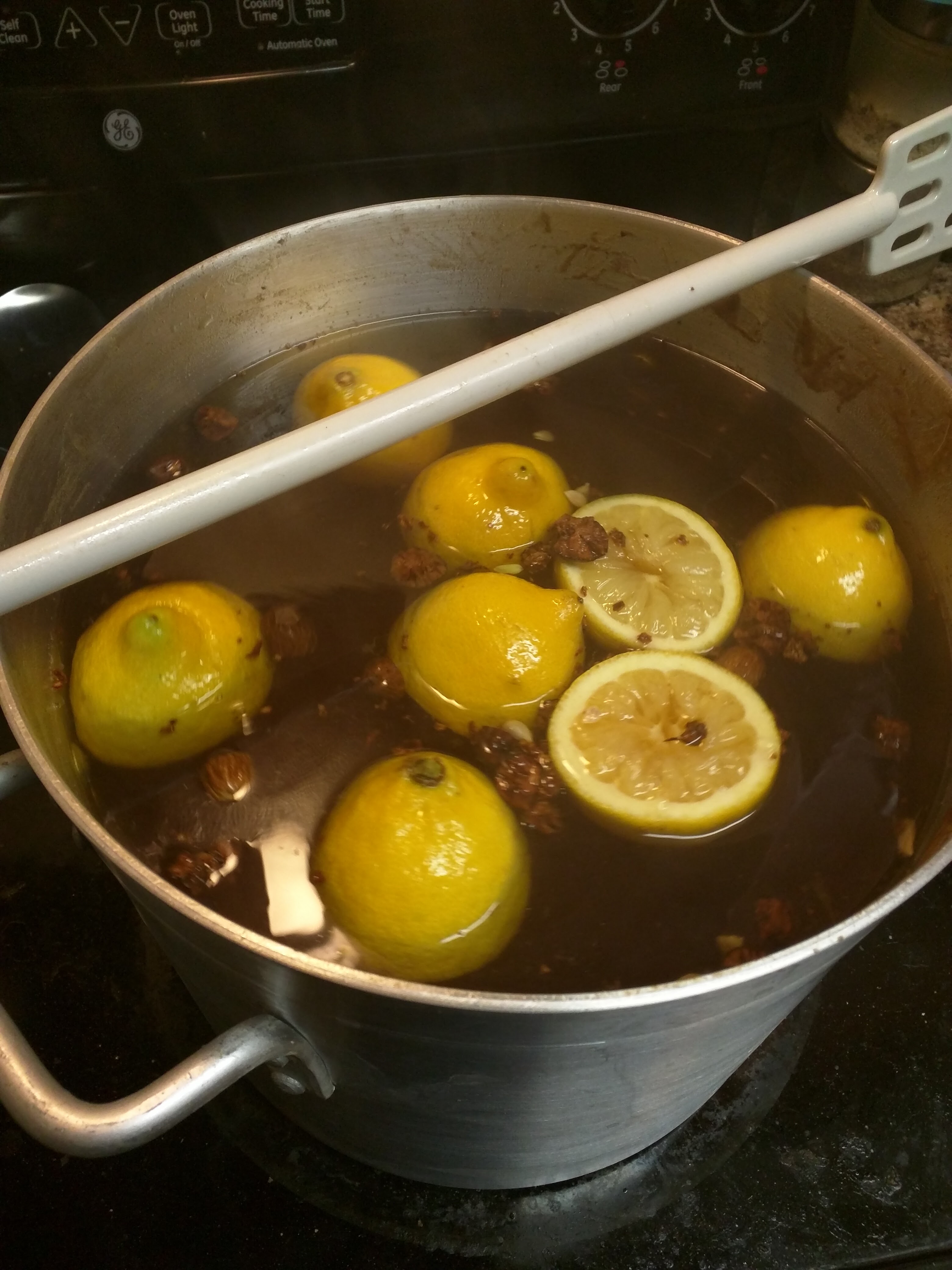 Lemons and nutmeg in honey on stove